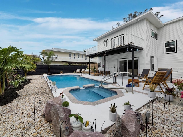 view of swimming pool featuring a fenced backyard, a patio area, and a pool with connected hot tub