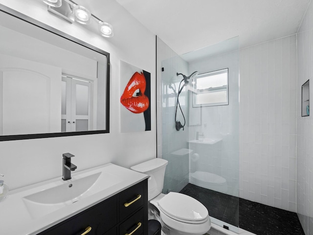 bathroom featuring walk in shower, toilet, and vanity
