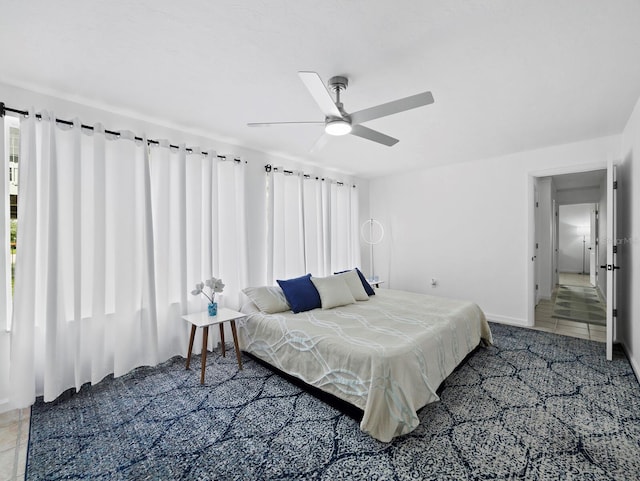 carpeted bedroom featuring ceiling fan and baseboards