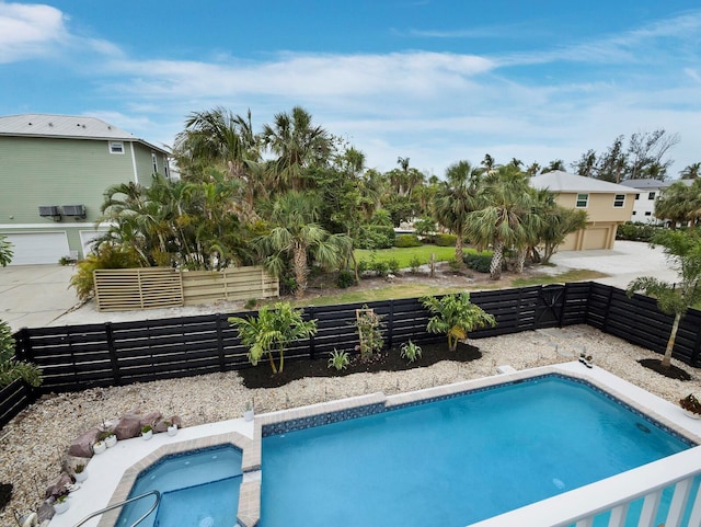 swimming pool featuring a fenced backyard