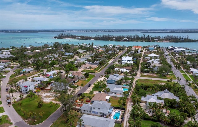 aerial view of property's location featuring nearby suburban area and a large body of water