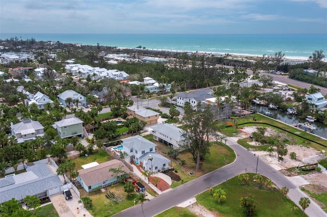 aerial view of property's location featuring a nearby body of water and nearby suburban area