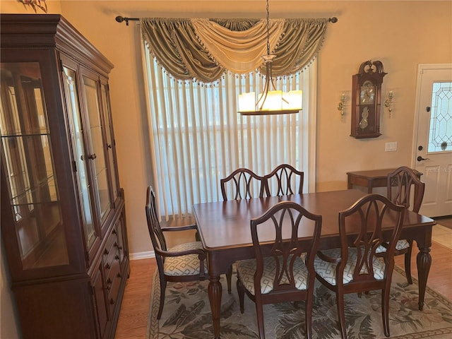 40 Mariner Ln, Rotonda West, FL 33947 - dining area featuring healthy amount of natural light, wood finished floors, baseboards, and a chandelier