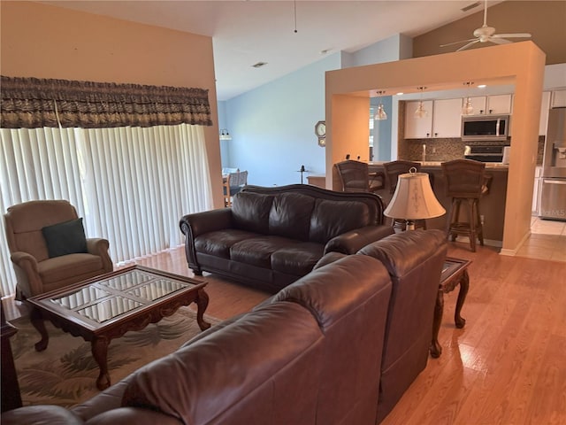 40 Mariner Ln, Rotonda West, FL 33947 - living area with lofted ceiling, a ceiling fan, light wood-type flooring, and plenty of natural light