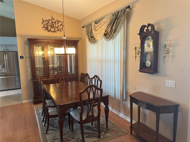 40 Mariner Ln, Rotonda West, FL 33947 - dining space with light wood-style flooring, baseboards, and lofted ceiling