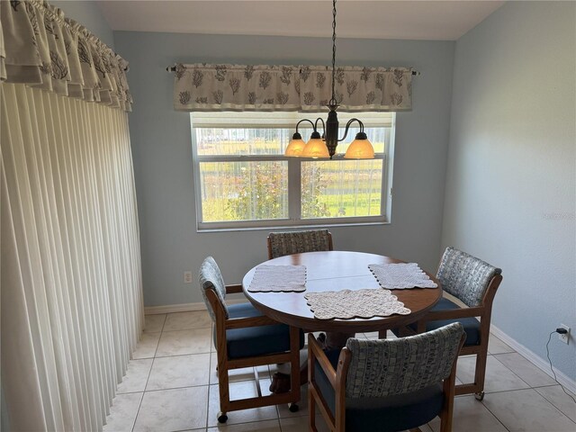 40 Mariner Ln, Rotonda West, FL 33947 - dining space with a chandelier, baseboards, and light tile patterned flooring