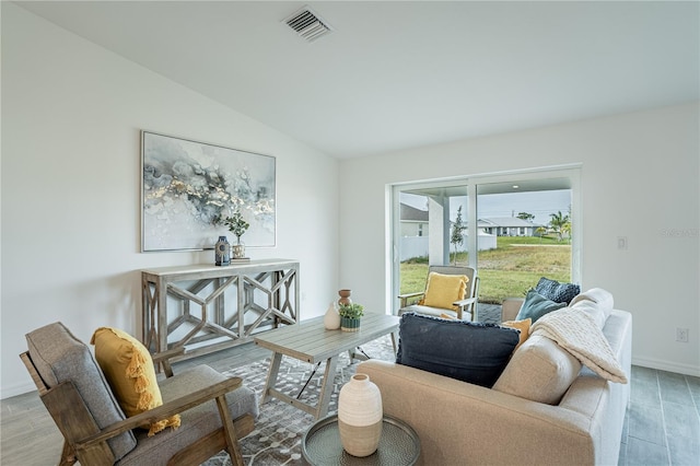 living room with baseboards, wood finished floors, and lofted ceiling