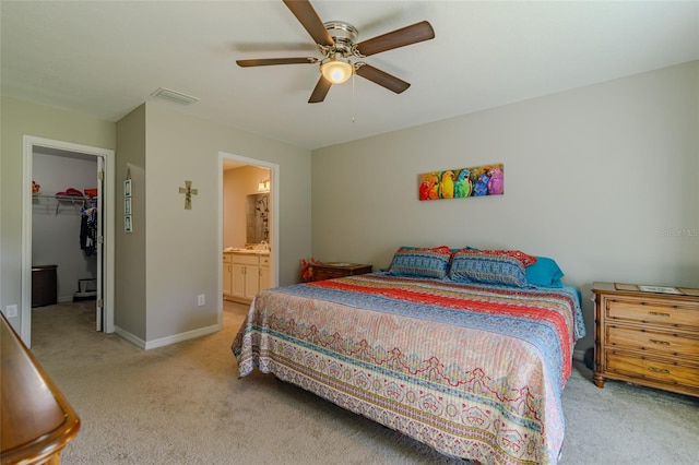9085 SW 202nd Avenue Rd, Dunnellon, FL 34431 - bedroom with light colored carpet, a walk in closet, connected bathroom, and ceiling fan