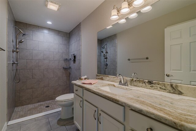 9085 SW 202nd Avenue Rd, Dunnellon, FL 34431 - bathroom featuring toilet, vanity, a tile shower, and tile patterned flooring