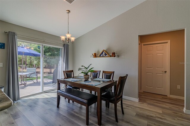 9085 SW 202nd Avenue Rd, Dunnellon, FL 34431 - dining area with a chandelier, wood finished floors, and baseboards