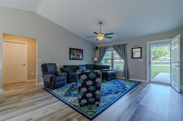 9085 SW 202nd Avenue Rd, Dunnellon, FL 34431 - living room featuring vaulted ceiling, light wood-style floors, a ceiling fan, and baseboards