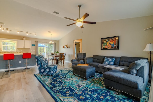 9085 SW 202nd Avenue Rd, Dunnellon, FL 34431 - living room with light wood-type flooring, a ceiling fan, vaulted ceiling, and baseboards