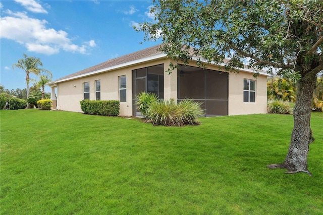 12183 Longview Lake Cir, Bradenton, FL 34211 - back of property featuring stucco siding, a yard, and a sunroom