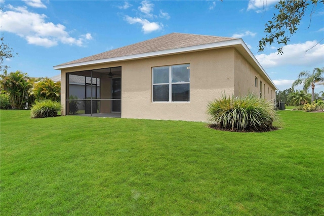 12183 Longview Lake Cir, Bradenton, FL 34211 - back of house featuring stucco siding, a lawn, and a sunroom