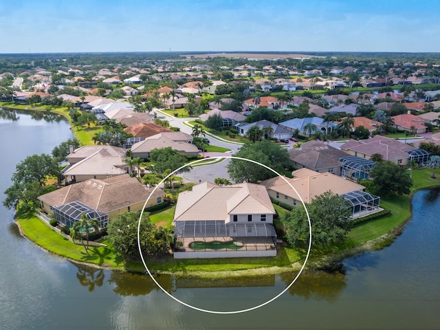 aerial view of residential area featuring a large body of water