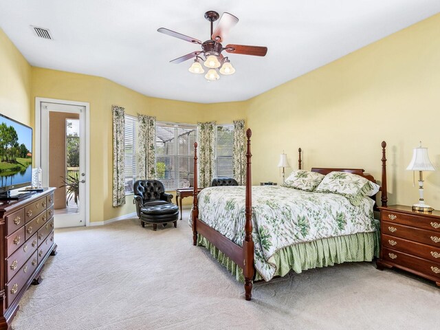 bedroom featuring light colored carpet, access to exterior, a ceiling fan, and baseboards