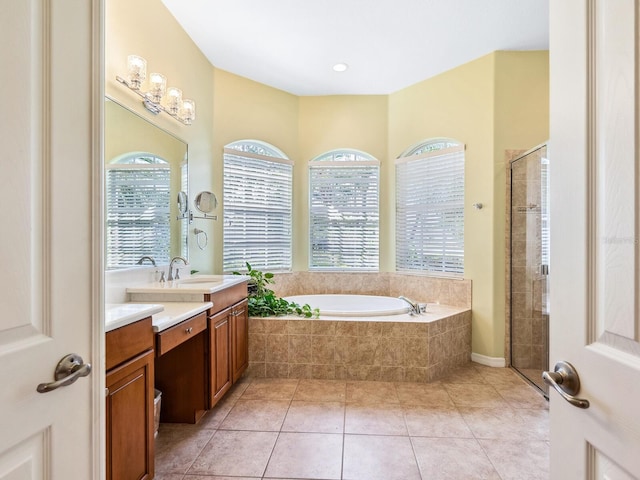 full bathroom featuring vanity, a shower stall, a bath, and tile patterned floors