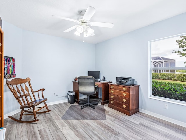 office area featuring light wood-type flooring, baseboards, and ceiling fan
