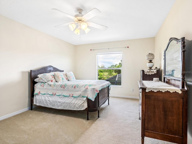 bedroom featuring light carpet, baseboards, and a ceiling fan