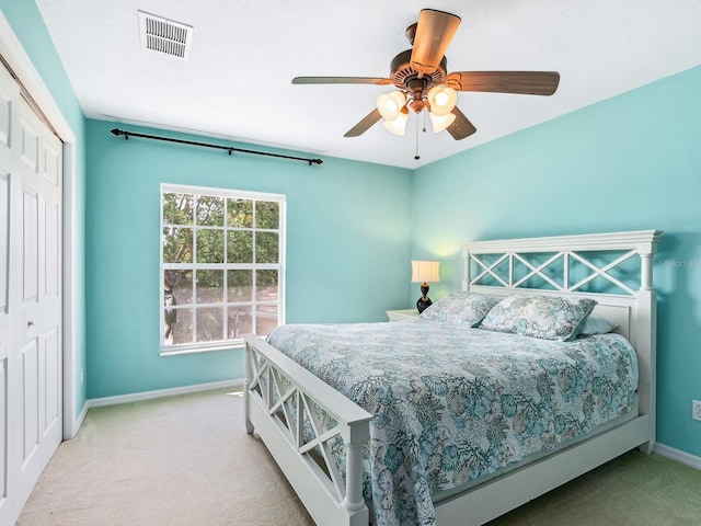 carpeted bedroom featuring baseboards, a closet, and ceiling fan