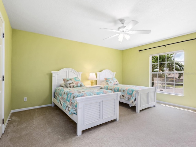 bedroom featuring carpet, baseboards, and ceiling fan