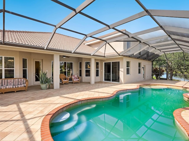 outdoor pool featuring a patio, a ceiling fan, an outdoor living space, and a lanai