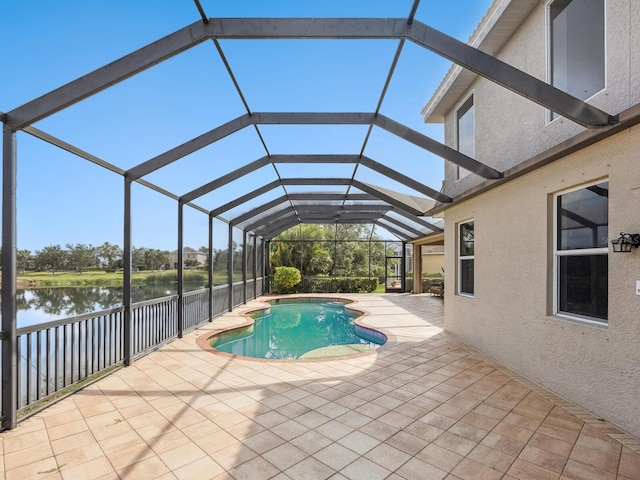 outdoor pool featuring a water view, a patio, and a lanai