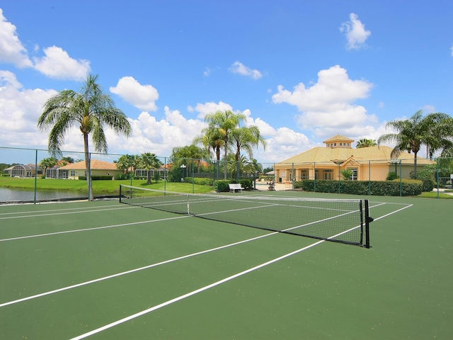 view of tennis court featuring fence