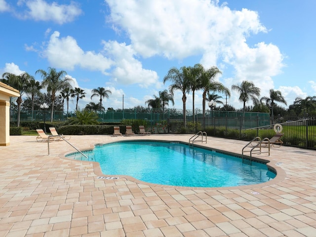 community pool featuring a patio and fence