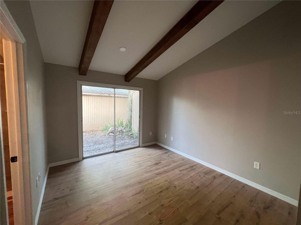 empty room featuring baseboards and wood finished floors