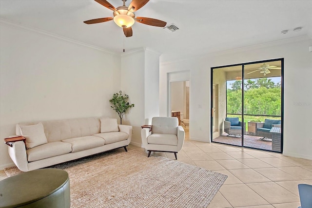 living area featuring ornamental molding, baseboards, a ceiling fan, and light tile patterned flooring