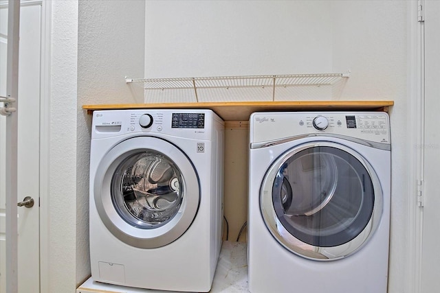 washroom with washing machine and dryer