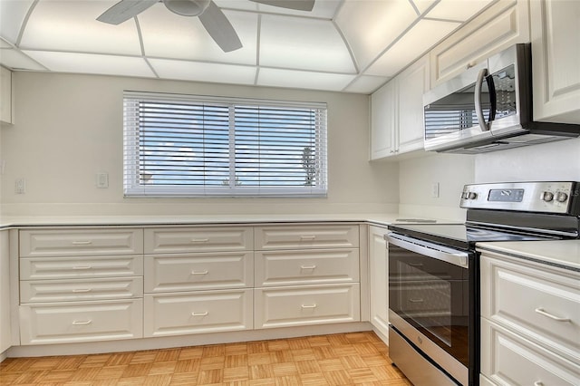 2675 Gulf Of Mexico Dr Unit 404, Longboat Key, FL 34228 - kitchen with appliances with stainless steel finishes, healthy amount of natural light, white cabinetry, and light countertops