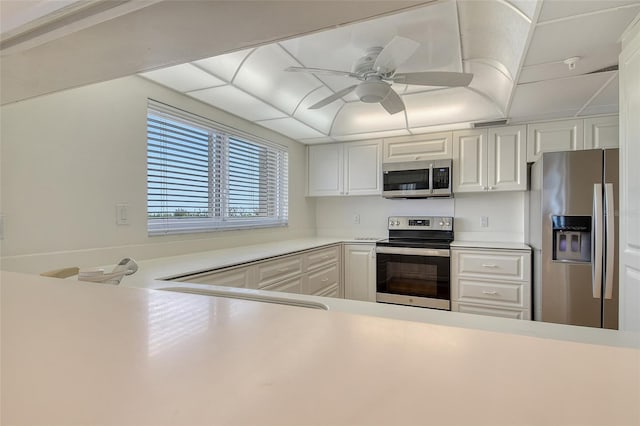 2675 Gulf Of Mexico Dr Unit 404, Longboat Key, FL 34228 - kitchen with stainless steel appliances, light countertops, ceiling fan, and white cabinetry