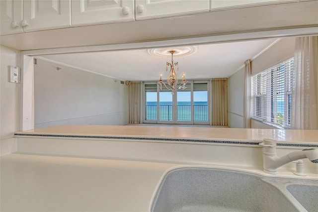 2675 Gulf Of Mexico Dr Unit 404, Longboat Key, FL 34228 - unfurnished dining area featuring healthy amount of natural light, a chandelier, and ornamental molding