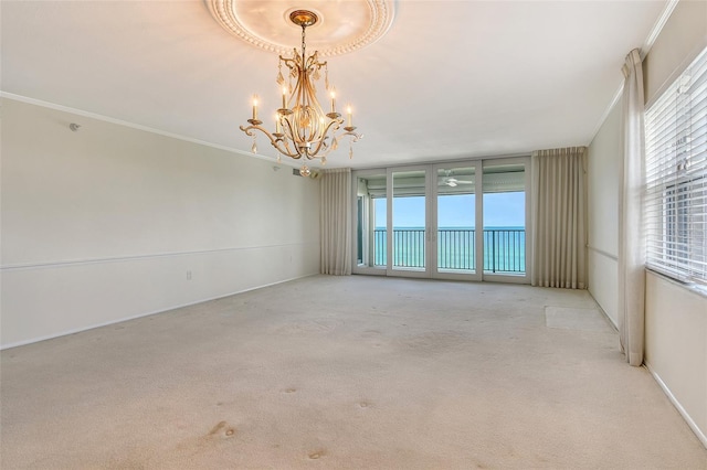 2675 Gulf Of Mexico Dr Unit 404, Longboat Key, FL 34228 - carpeted spare room featuring a chandelier and crown molding
