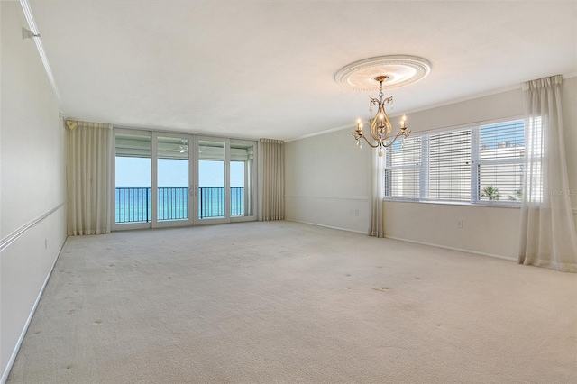 2675 Gulf Of Mexico Dr Unit 404, Longboat Key, FL 34228 - carpeted empty room with a chandelier and crown molding