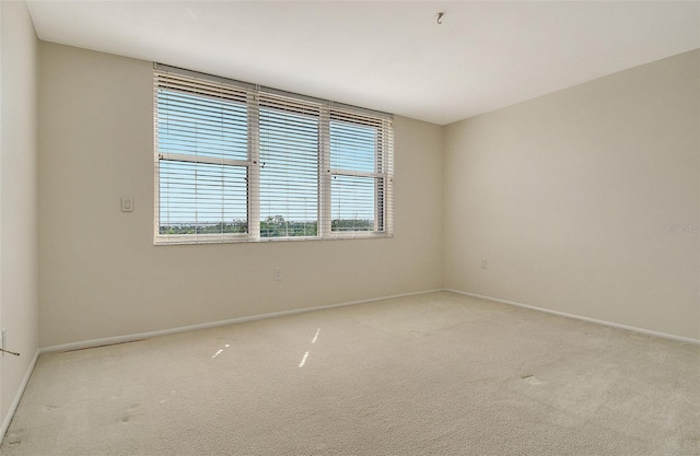 2675 Gulf Of Mexico Dr Unit 404, Longboat Key, FL 34228 - spare room featuring baseboards and light colored carpet