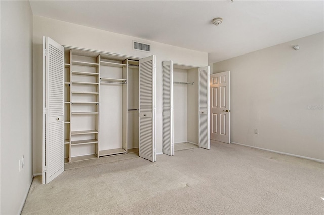 2675 Gulf Of Mexico Dr Unit 404, Longboat Key, FL 34228 - unfurnished bedroom with two closets and carpet flooring
