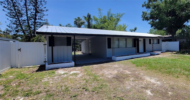 4210 Baird St, Sarasota, FL 34232 - view of front of property with a gate, a carport, fence, and dirt driveway