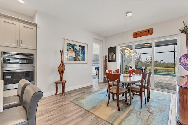 dining room with light wood finished floors and baseboards