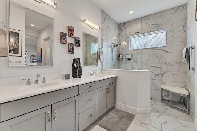 bathroom featuring marble look tiles, a walk in shower, double vanity, and recessed lighting