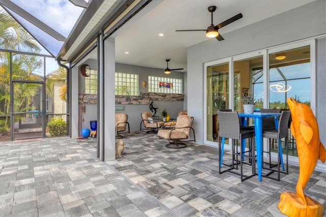 sunroom featuring a ceiling fan