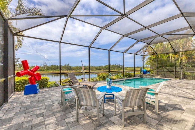 swimming pool with a water view, a patio area, and a lanai