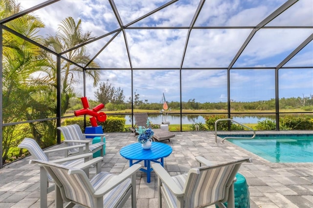 view of patio featuring a water view, a lanai, and an outdoor pool