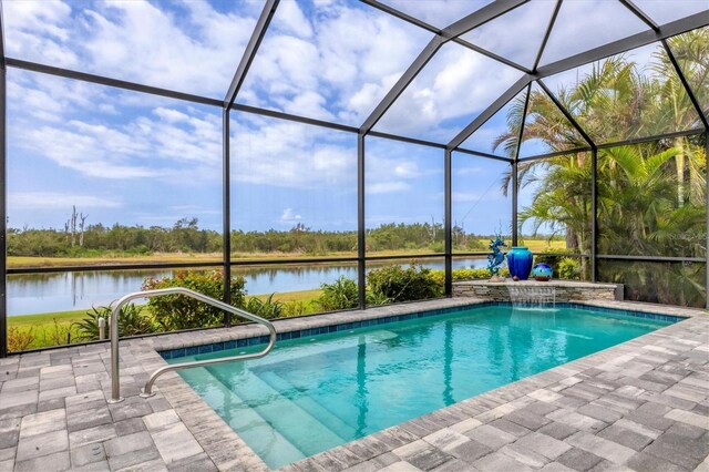 outdoor pool featuring a water view, a patio area, and glass enclosure