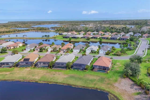 aerial view of residential area featuring a nearby body of water