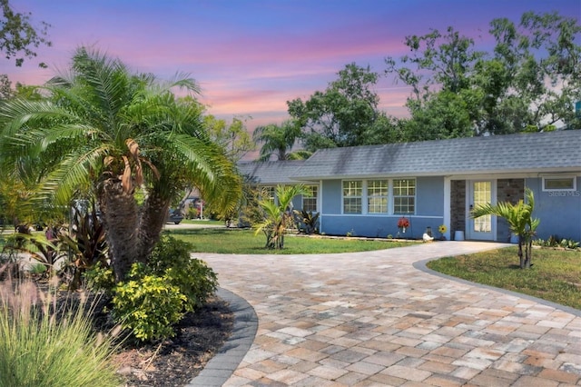 6931 Magellan Way, Sarasota, FL 34243 - single story home featuring stucco siding, decorative driveway, and a lawn
