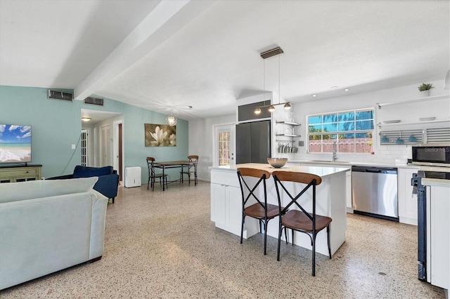 6931 Magellan Way, Sarasota, FL 34243 - kitchen with stainless steel appliances, white cabinets, beam ceiling, open shelves, and light countertops
