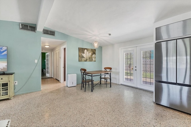 6931 Magellan Way, Sarasota, FL 34243 - dining space featuring speckle patterned floor, french doors, and beamed ceiling